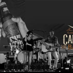 Live band performing on stage with logo